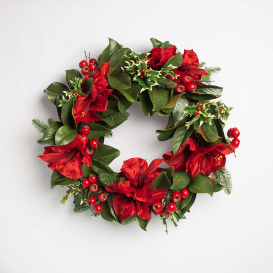 decorative christmas wreath with red berries and flowers on a white background