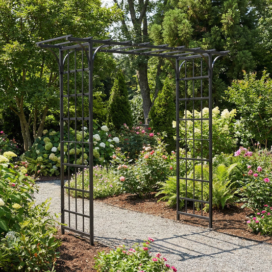 H Potter metal garden archway in a lush garden setting with flowers and trees.
