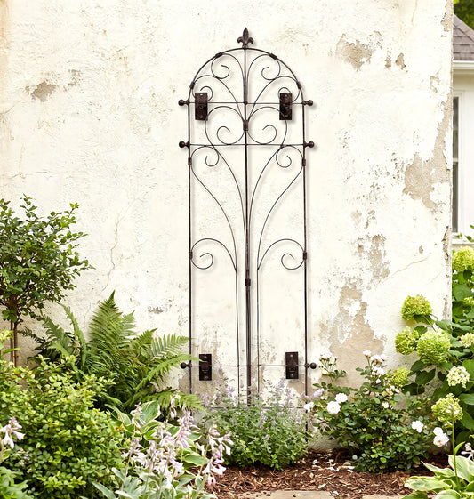 H Potter Italian Wall Trellis on a stucco house above landscaped garden plants