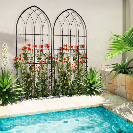 Decorative metal wall art with floral design next to a pool