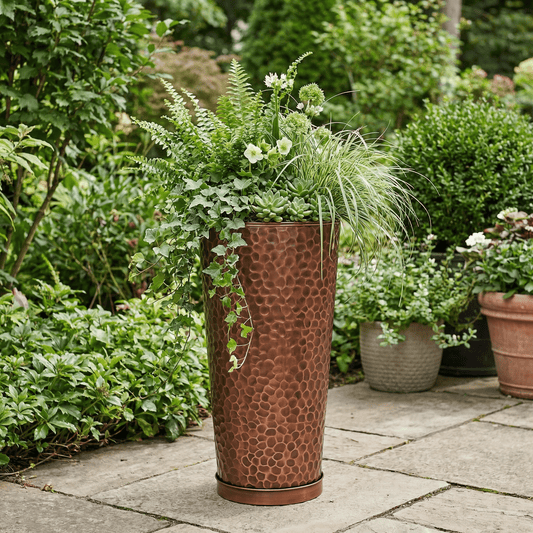 h potter tall column planter in a garden on a stone patio